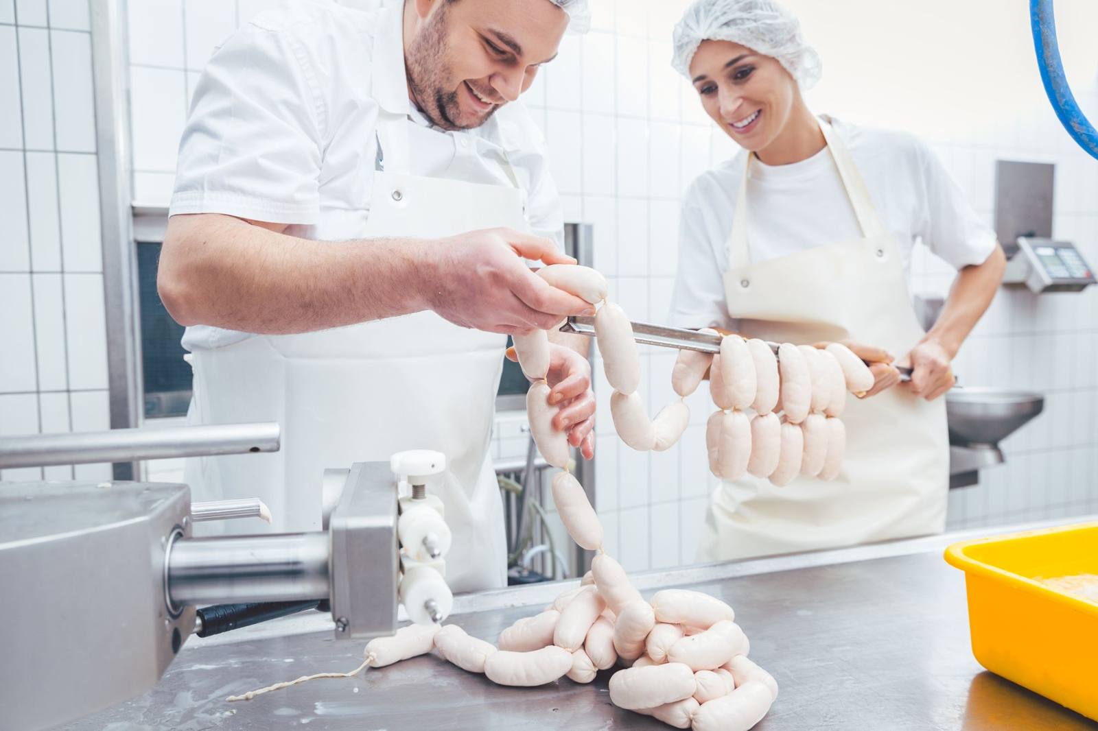 Food production workers at a stainless-steel line