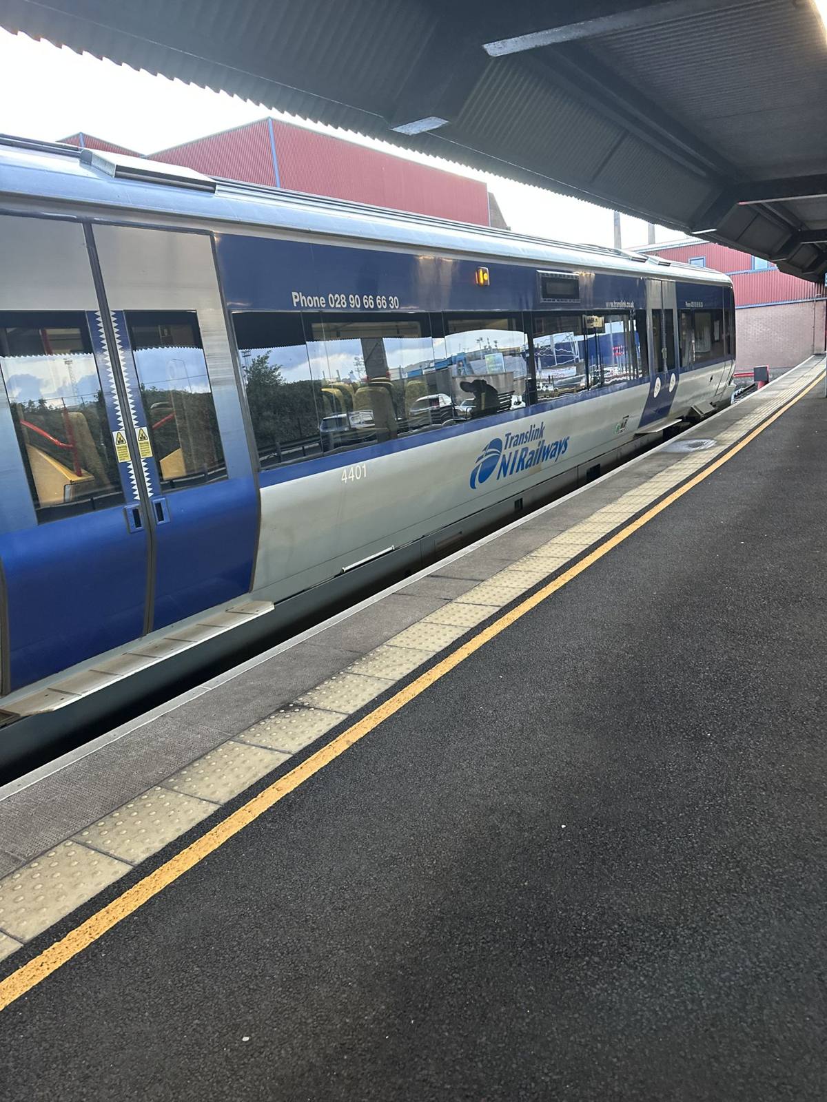 A Northern Ireland Railways train at a station platform